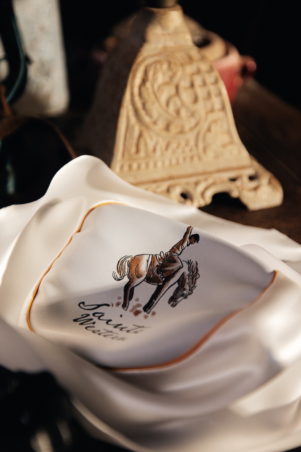 The bucking horse mark, stitched.