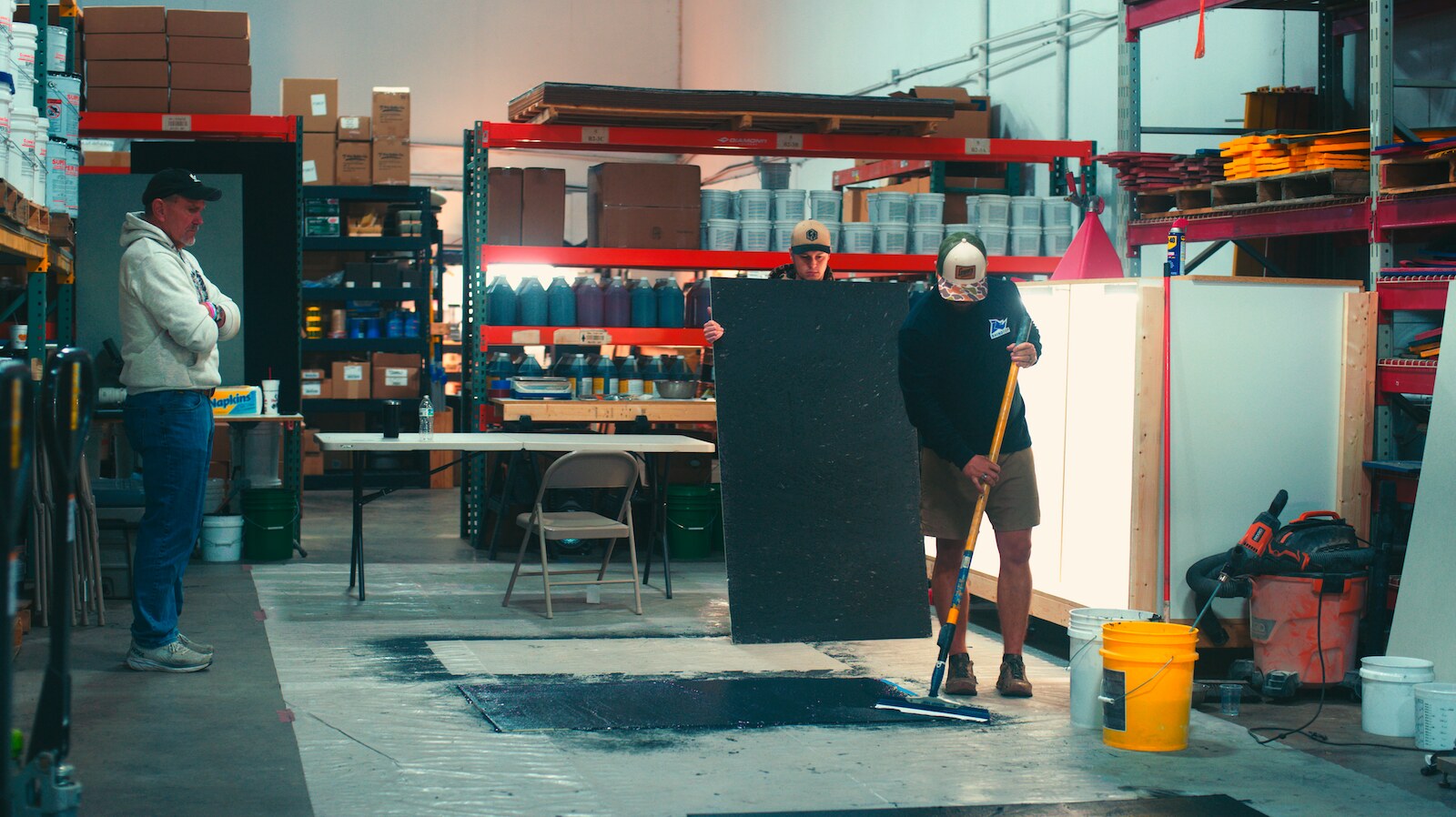 Test pour in the shop  -  the crew watching the squeegee pass.