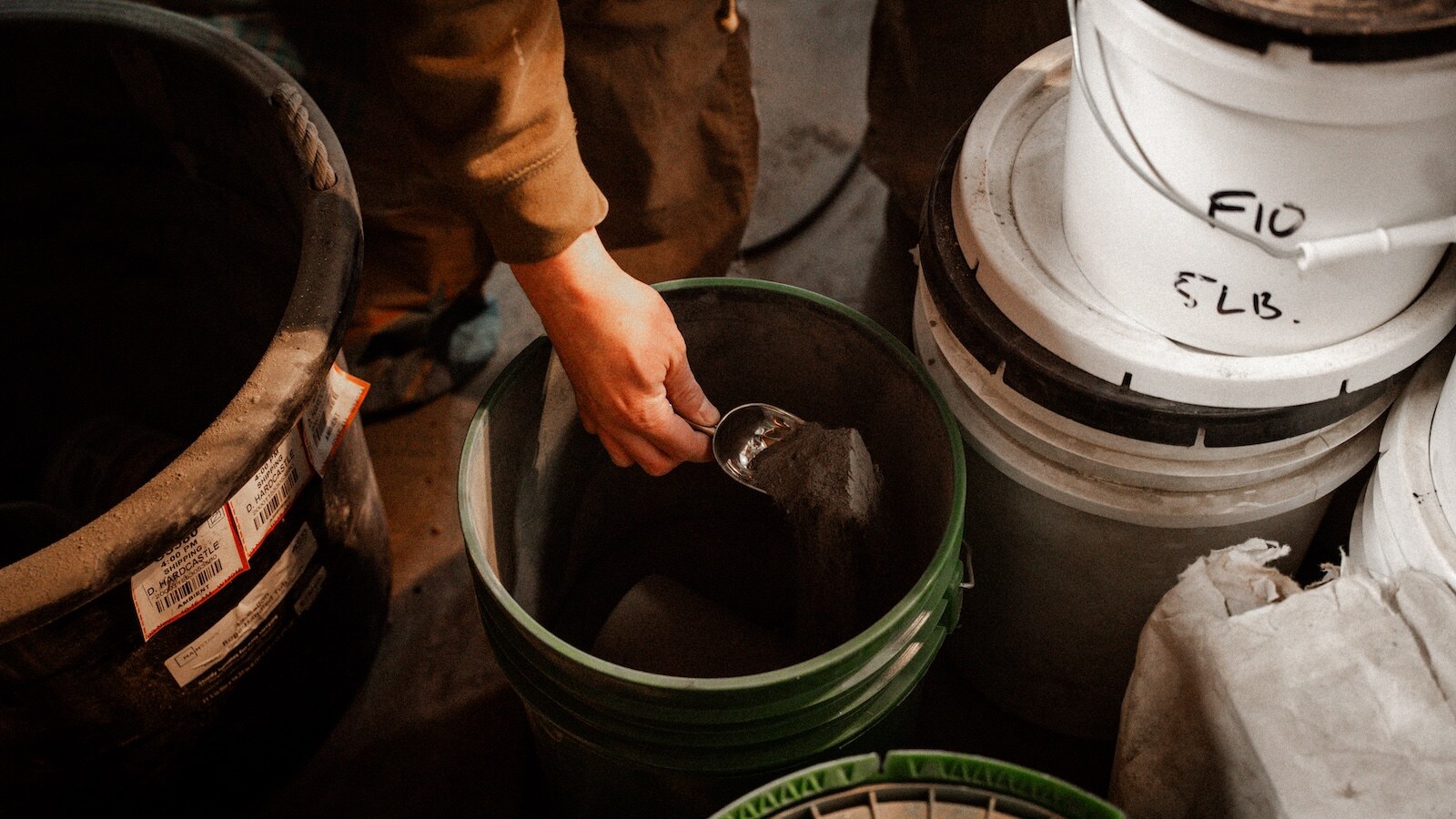 Weighing raw material by hand before a mix trial.
