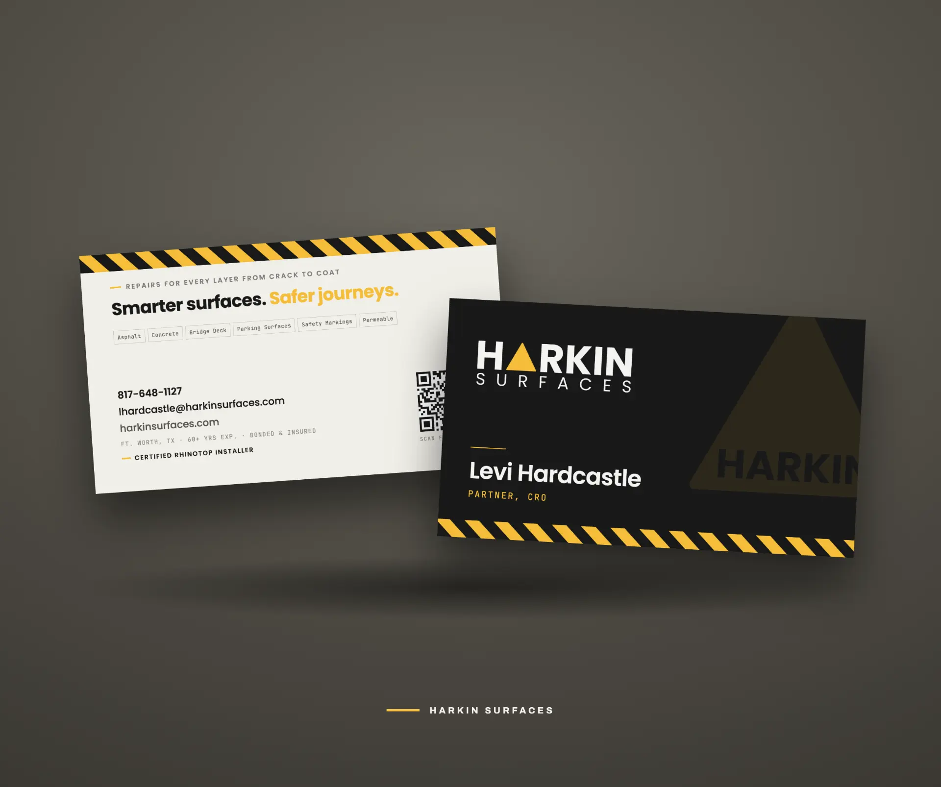 Harkin Surfaces business cards showing the mark, hazard-stripe graphic language and typography